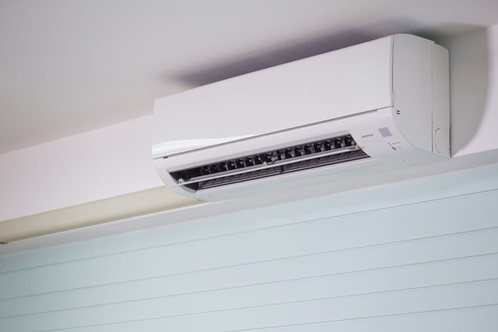 Close-up of a wall-mounted air conditioner indoors, showcasing sleek design for modern cooling solutions.